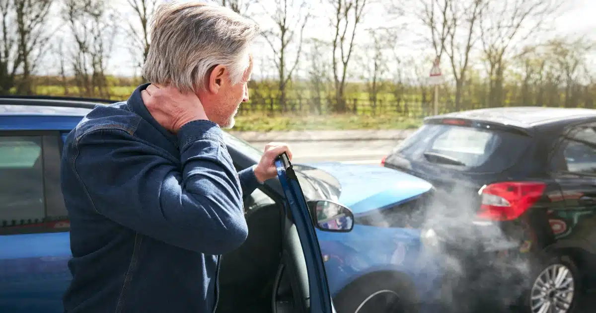 Man inspecting car accident damage representing motor vehicle cases eligible for pre-settlement funding