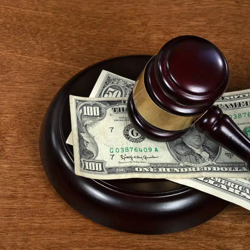 gavel on top of money representing how important attorney approval is to get Oregon pre-settlement funding