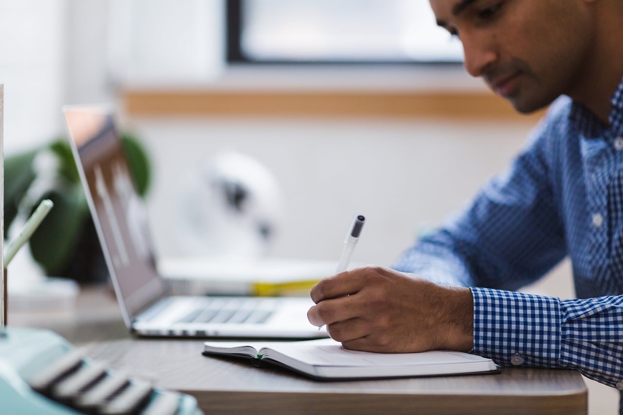 A person sitting at a desk reviewing documents with an attorney, representing the legal consultation process for a car accident claim